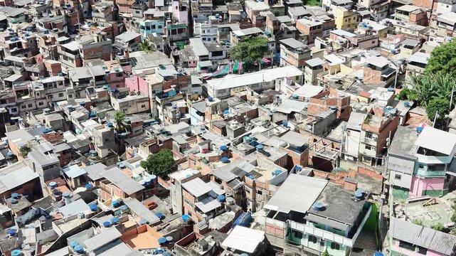Aerial drone view of Favela Of Cantagalo, Rocinha favelas spread out on the mountain in Sao Conrado , Rio de Janeiro, Brazil.