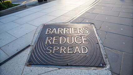 Metal Plate Reads Barriers Reduce Spread on Sidewalk