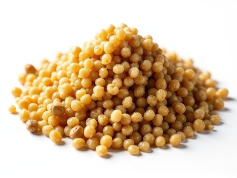 A pile of yellow grains on a white surface, suitable for use in still life or food-related compositions