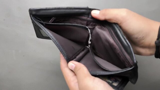 Hands Searching Empty Black Leather Wallet For Cash