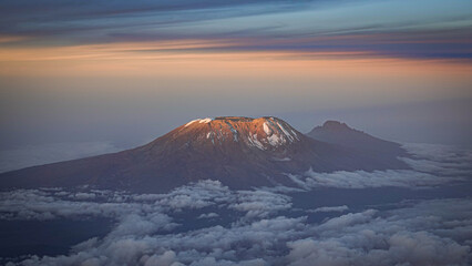 Mount Kilimanjaro seen from the air with dramatic light over the landscape © Rami