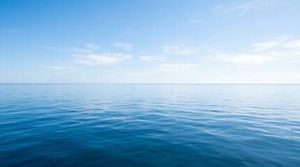 Obraz premium Serene ocean horizon with calm waters reflecting a clear blue sky viewed from a distant perspective