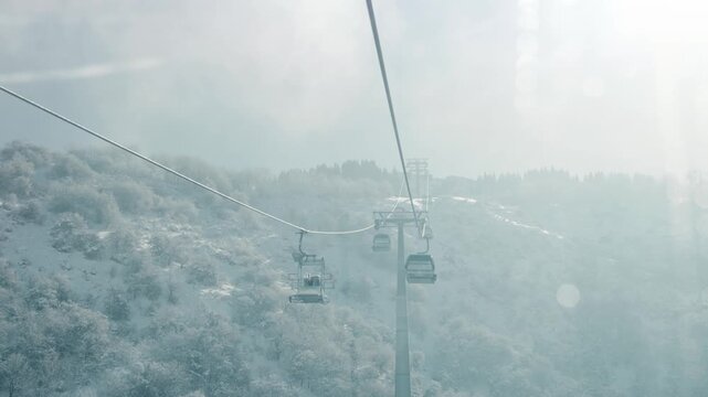 Cable car gondola at mountain valley with snow