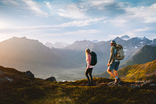 Couple hiking in Norway man and woman travel together in Lofoten islands, friends on active summer vacation healthy lifestyle family trekking outdoor adventure backpacking trip eco tourism