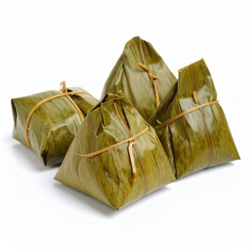 the image shows a group of four pyramidal or square shaped packages wrapped in leafy green coverings. these packages, likely food items, are bound together with thin, light brown string