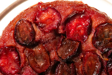 Richly-hued plum tart tantalizes taste buds, perfect for European Easter feasts or obscure...