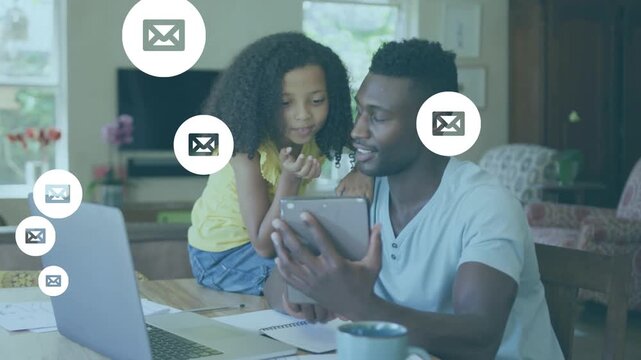 Animation of message icons moving over happy african american father showing tablet to daughter