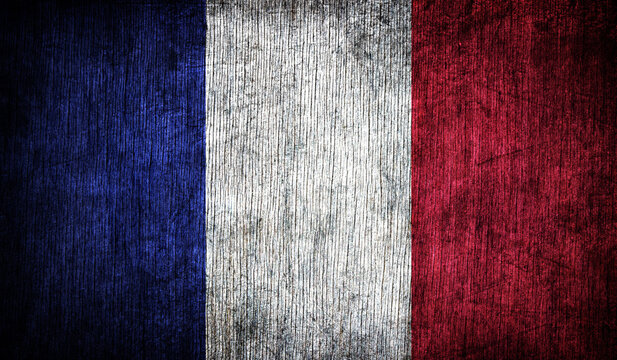 Abstract retro flag of France on a wooden background.