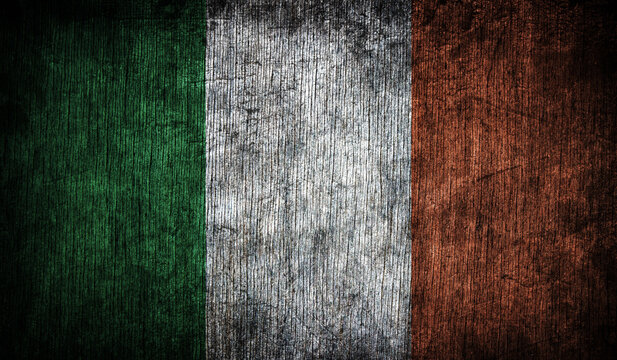 Abstract retro flag of Ireland on a wooden background.