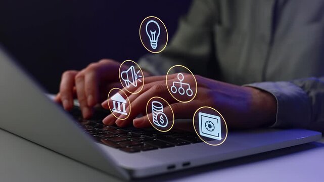 Person types on laptop with digital icons representing ideas, sound, data, and money at nighttime indoors.