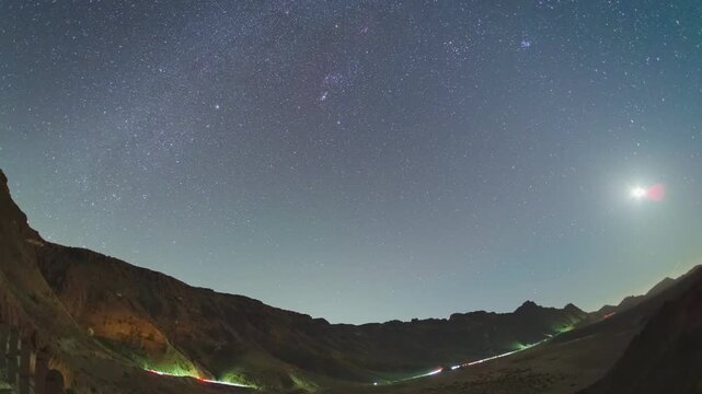 4K timelapse Dynamic cloud formation over Tenerife's Orotava Valley, viewed from above with a vast sea of white clouds rolling in under clear blue sky, revealing lush greenery and distant towns below