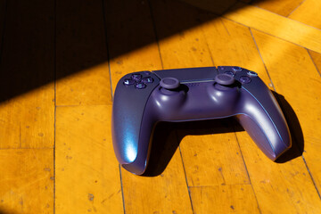 A gamepad for consoles on a white background, gaming addiction, gaming ban for teenagers, gaming controls for parents, for banners and advertising. High quality © Karen Vardanian