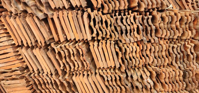 Closely arranged roofing tiles made of clay. Mangalore tiles pile