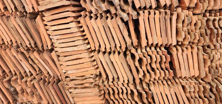 Closely arranged roofing tiles made of clay. Mangalore tiles pile