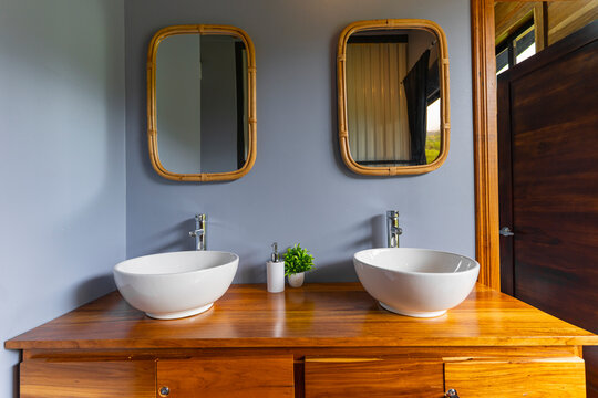 Bathroom vanity with two sinks and bamboo mirrors