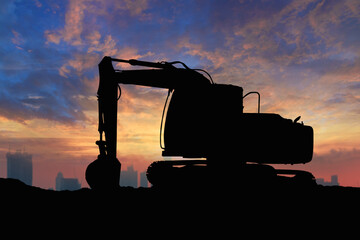 Crawler excavators silhouette are digging the soil in the construction site on  sky and cloud  background. © chaphot