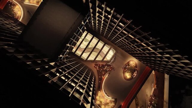 Top-down drone view of modern office complex courtyard with illuminated pathways, landscaped design, and contemporary architecture at night in Vilnius, Lithuania.