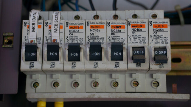 Electrical circuit breaker panel with MCB and UPS switches in industrial setting