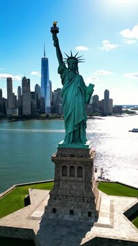 A Majestic View of the Statue of Liberty: Iconic Symbol of Freedom and Hope Standing Tall Amidst the Scenic New York City Skyline and Blue Waters