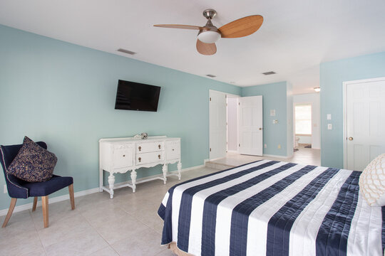 Clean blue primary bedroom in a Florida vacation rental house
