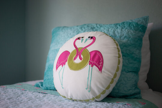 Charming Coastal Bedroom with Flamingo Accent Pillow and Soft Aqua Bedding