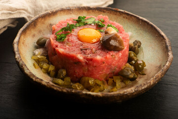 Beef Steak Tartare with Quail Egg on Handmade Ceramic Plate