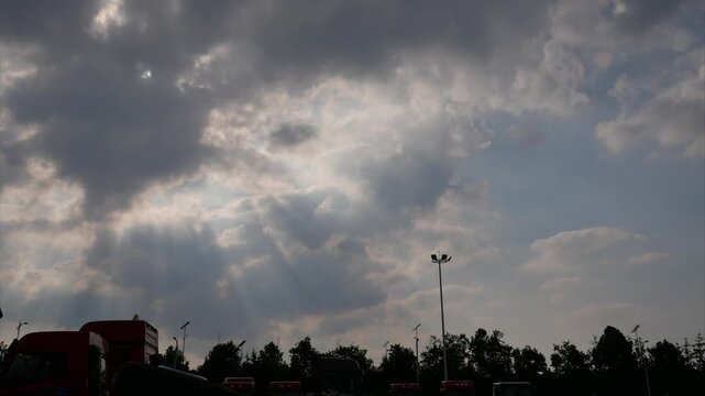 Dramatic Storm Sky with God Rays and Silhouetted Landscape