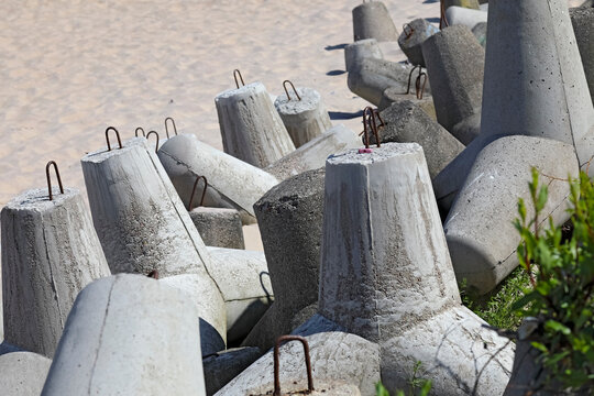 Heavy, multi-arm reinforced concrete blocks separate the beach from the dunes in Mielno, Poland