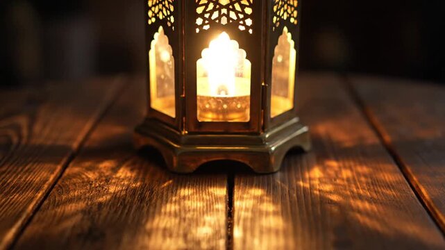 Ornate candle lantern on rustic wooden table with warm ambient light