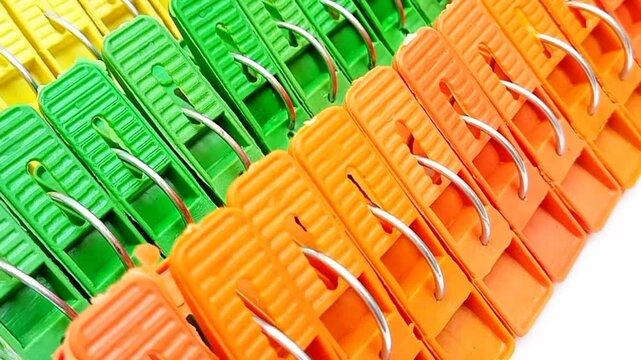 Clothes pegs sets, sets of multicolor plastic clothes pins or laundry clips for house moving on the white background