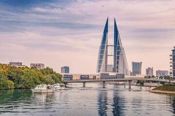 2 December 2025, Bahrain, Manama: World Trade Center standing tall along a busy canal with boats