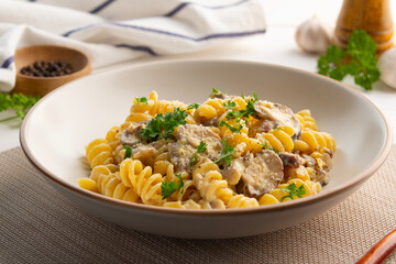 Pasta with creamy mushroom sauce,eliche pasta with shiitake mushroom and parsley in white plate.Italian traditional dish.