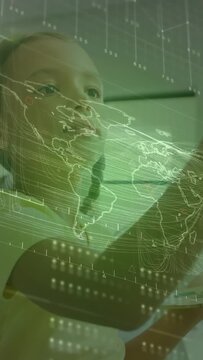 Vertical video: Student raising arm sweeping green map overlay and causing data lines for learning