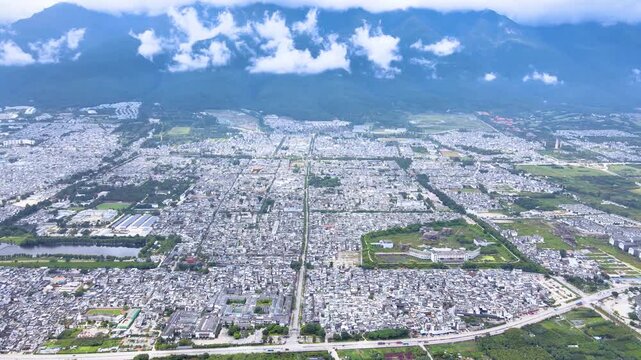 Aerial City Sprawl with Snow-Capped Mountains