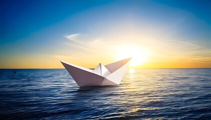 A paper boat floats serenely on calm ocean waters under a vibrant sunset sky
