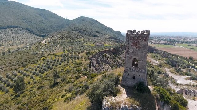 Caprona, Tuscany. Aerial view of famous medieval tower on the mountain top. Slow motion
