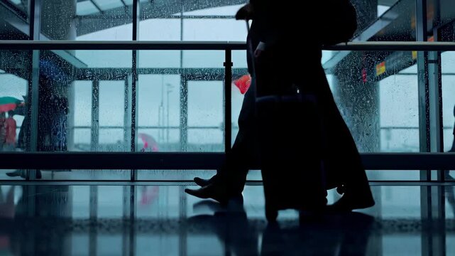 airport terminal rainy day, travelers umbrellas behind rain-streaked glass, reflections wet floors, luggage rolling, cinematic moody lighting, HDR, slow-motion blur, volumetric light shafts, dynamic