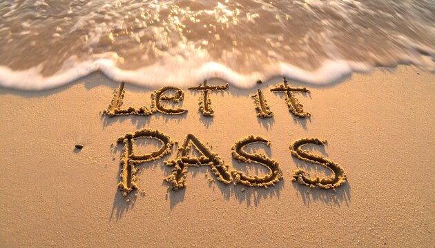Inspirational phrase let it pass written in beach sand with gentle ocean waves approaching for mindfulness and emotional release conceptual photography imagery