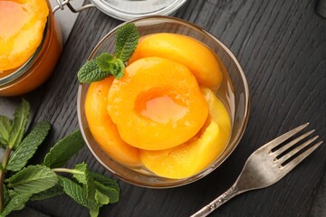Pickled peaches and mint leaves on grey table, flat lay © New Africa