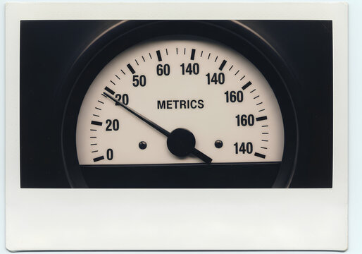 Closeup of a vintage analog speedometer gauge with metric units.