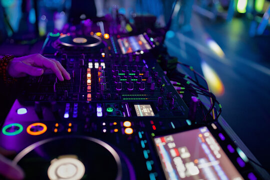 DJ Mixing Music on a Console at a Nightclub