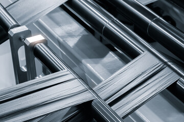 Automatic polyethylene plastic bag production machine with lighting effect. Close-up of the roller of the plastic bag production machine in the light blue scene. product packaging concept