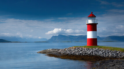 Obraz premium Lighthouse on Rocky Shore with Mountain Landscape