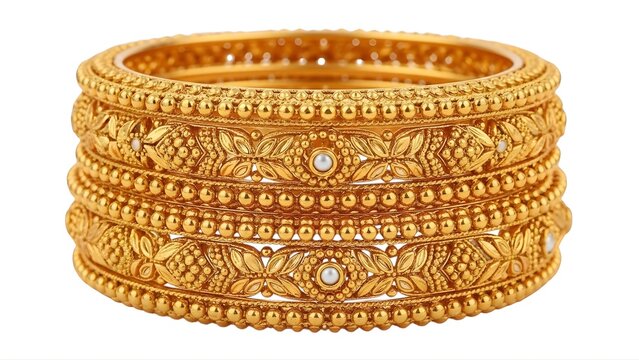A stack of intricately designed gold bangles on transparent background