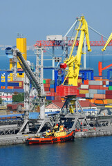 Fototapeta premium Tugboat and port cargo crane