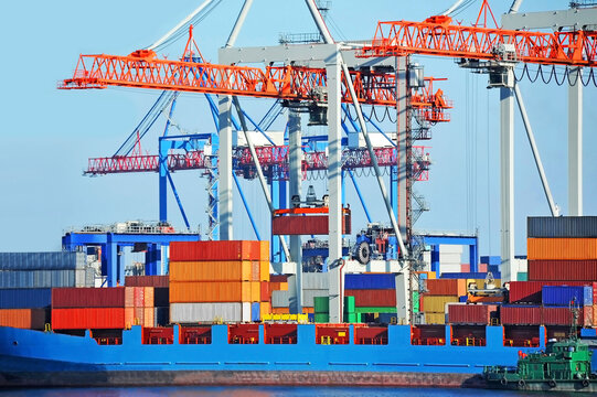 Crane loading container to cargo ship deck