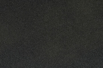Fototapeta premium Black sandpaper texture with rough surface showing fine grain details clearly