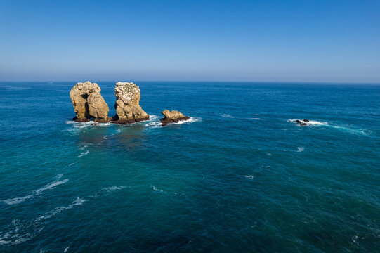 Urro del Manzano at sunset, Liencres, Spain. Rock formation natural arch bridge in Arnia Costa Quebrada.. Cantabria landscape, sea and beautiful colores.