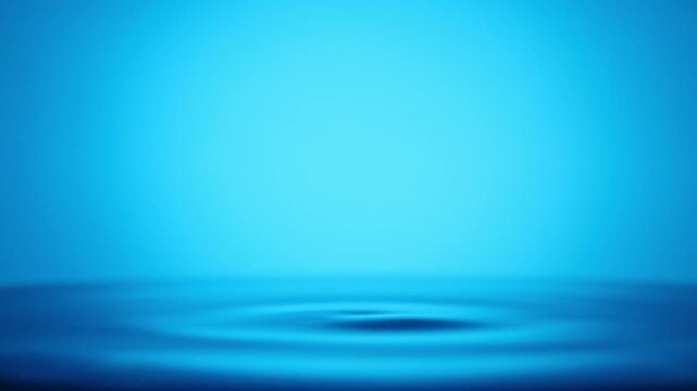 A captivating image of water droplet impact with ripples expanding outwards in gradient blue. The surface of the water reflects a soft, ethereal light