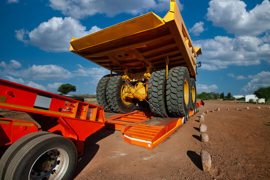 Mining truck abnormal load transport lowboy trailer African dirt road logistics